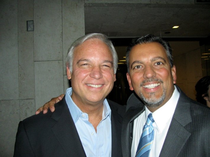 Mike in a suit and tie smiling alongside author Jack Canfield